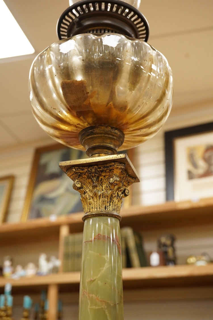 An onyx oil lamp with glass reservoir, 82cm high